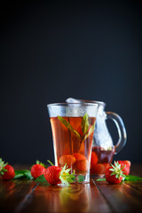 Sweet compote of ripe red strawberries in a glass decanter