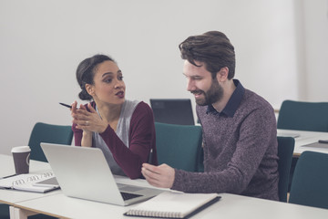 Man and Woman Working Together in Office