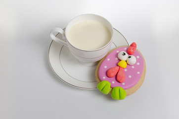 Cup with milk and cake on a saucer on a white background, top view
