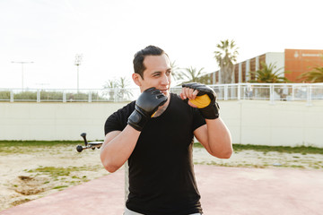 Young concentrated strong sports man boxer