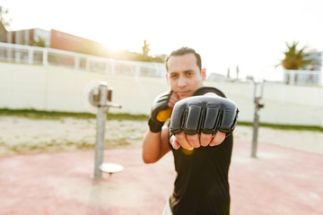 Young concentrated strong sports man boxer