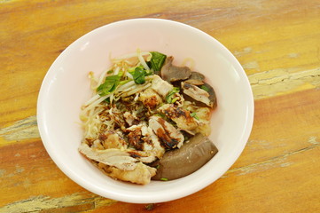 dry thin rice noodles with slice duck meat dressing black sweet soy sauce on bowl