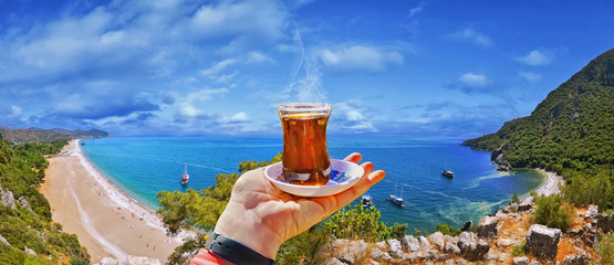 Morning cup of tea with view of colorful panoramic Olympos beach , Cirali, Antalya Province ,Turkey - obrazy, fototapety, plakaty