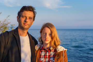 Portraits of father and daughter in the summer at sunset on the