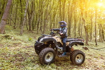 Fototapeta premium The boy is traveling on an ATV.