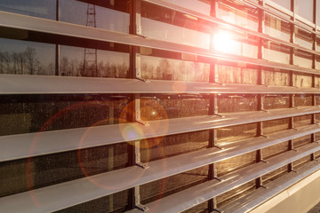 Reflection of the sun with glare from the window with a lattice