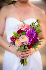 Obraz na płótnie Canvas Bride Holding Bouquet of Colorful Flowers