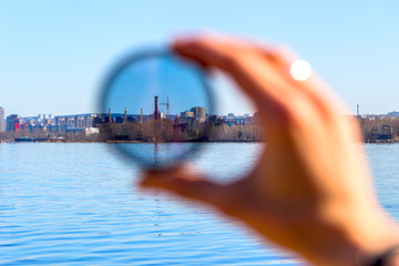 City through a polarizing filter in the female hand