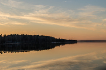 Beautiful sunset with the reflection of the sky and the background of the island