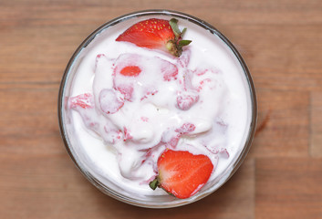 Melted vanilla ice cream with strawberry slices