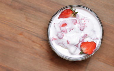 The delicious vanilla ice cream with slices of strawberries was melted