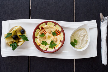 Traditional Arabic breakfast, lettuce, eggs, cheese, olives, and decorative vegetables, served on a plate, restaurant, service