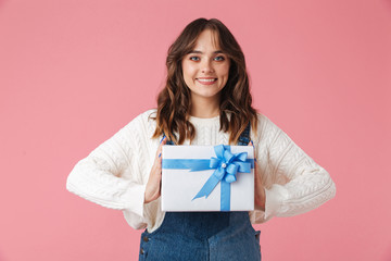 Portrait of a happy young girl holding present box