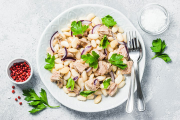 White bean tuna salad on concrete background. Top view, space for text.