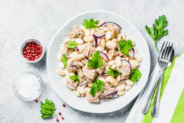 White bean tuna salad on concrete background. Top view, space for text.