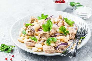 White bean tuna salad on concrete background. Selective focus, space for text.