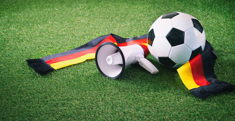 Soccer ball with german fan scarf and megaphone © Alexander Raths
