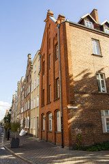 The facade of the beautiful historic building on the street of the Old Town of Gdansk. Poland