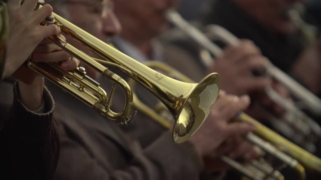 Close-up of wind instruments. Jazzman plays the trumpet. Brass tool.