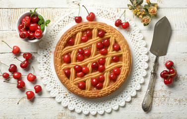 cherry tart with fruits around on white table