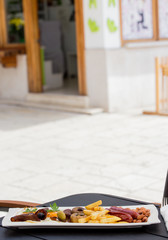 Traditional american breakfast, sausages, eggs, beans, french fries, and decorative vegetables, served on a plate, restaurant, service