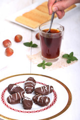 Cookies of El Fitr Islamic Feast - Man putting sugar in glass of tea - Biscuits with cup of tea for iftar in Eid fitri