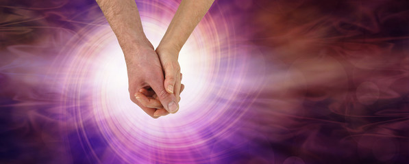 The Power of Love - male and female holding hands against a red pink rotating vortex of white...