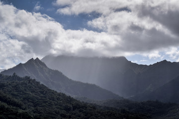 Obraz na płótnie Canvas Light shines through clouds over fields in Hawaii