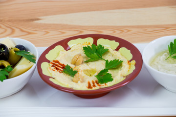 Traditional Arabic breakfast, lettuce, eggs, cheese, olives, and decorative vegetables, served on a plate, restaurant, service