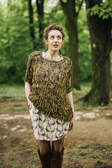 Fototapeta premium Young woman wearing sweater and posing the park
