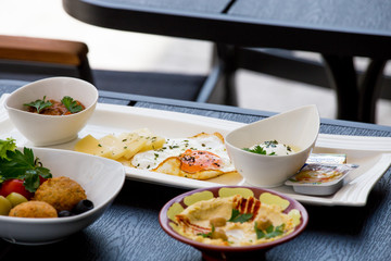 Traditional Arabic breakfast, lettuce, eggs, cheese, olives, and decorative vegetables, served on a plate, restaurant, service
