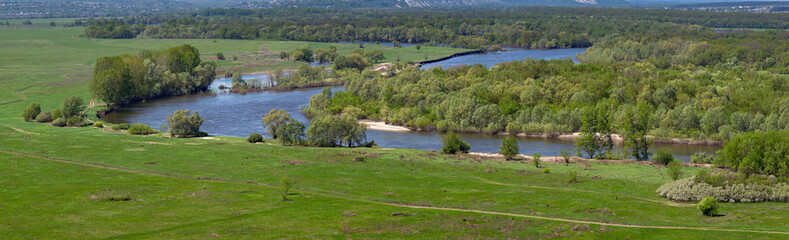 Landscape in the valley of the Don River in central Russia. Top view of the spring meadow with grass and pond.