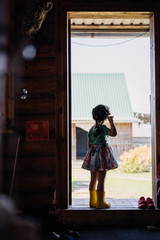 girl on the threshold of a village house photo from the back
