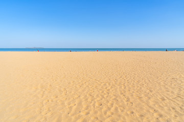 The sea and sand under a clear sky