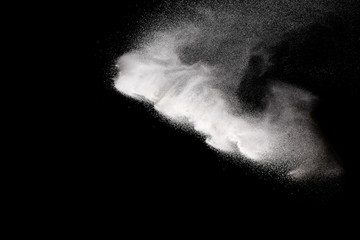 Fototapeta na wymiar Bizarre forms of white powder explosion against dark background. Launched white particle splashing.