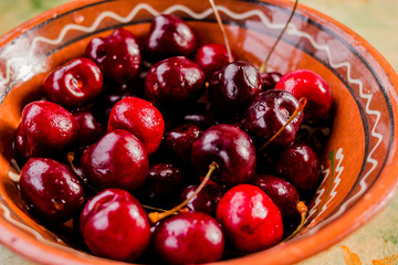 Fresh organic sweet cherries on ceramic bowl Healthy food concept. Summer fruits. Red fresh cherry
