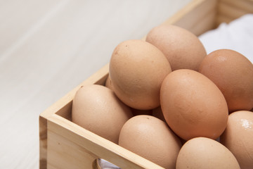 Many eggs are on wooden boxes.
