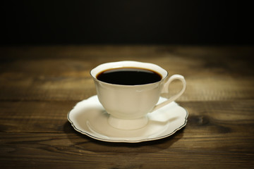 Hot coffee isolated on wooden table
