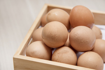 Many eggs are on wooden boxes.