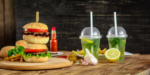 burgers with meat, tomato and lettuce leaves  - fast food (sandwich) - cuisine.  Food background