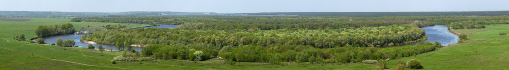Obraz premium Landscape in the valley of the Don River in central Russia. Top view of the spring meadow with grass and pond.
