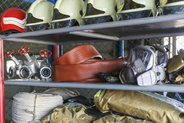 Fire safety. A rack with emergency stock for extinguishing a fire. Helmet, gloves, goggles,...