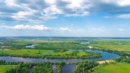 Fototapeta na wymiar Aerial top view of Kyiv cityscape, Dnieper and Dniester river, green island from above, Kiev city skyline and nature parks in spring, Ukraine 