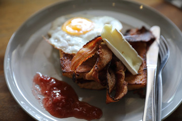 Breakfast french toast with bacon egg and cheese with jam on wood table background