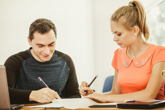 Two Students Talking In Classroom