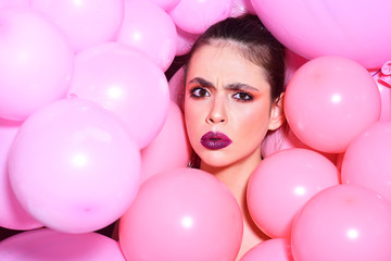 Fototapeta na wymiar Balloon party on pink studio background. Birthday decor and celebration. girl dreaming in punchy pastels trend. Retro girl with stylish makeup and hair. Fashion woman with many pink air balloons