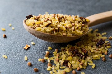Raw Bulgur Rice with Buckwheat in Wooden Spoon / Bulghur for Pilav or Pilaf