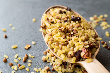 Raw Bulgur Rice with Buckwheat in Wooden Spoon / Bulghur for Pilav or Pilaf