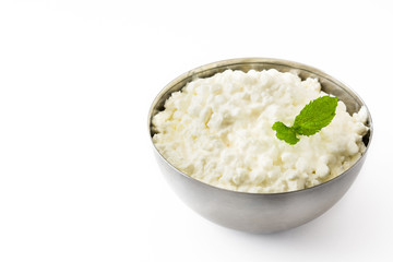 Fresh cottage cheese in a metal bowl isolated on white background. Copyspace