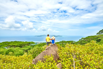 Young couple in love looking at sea and islands from the top of island Seychelles / Highest point...